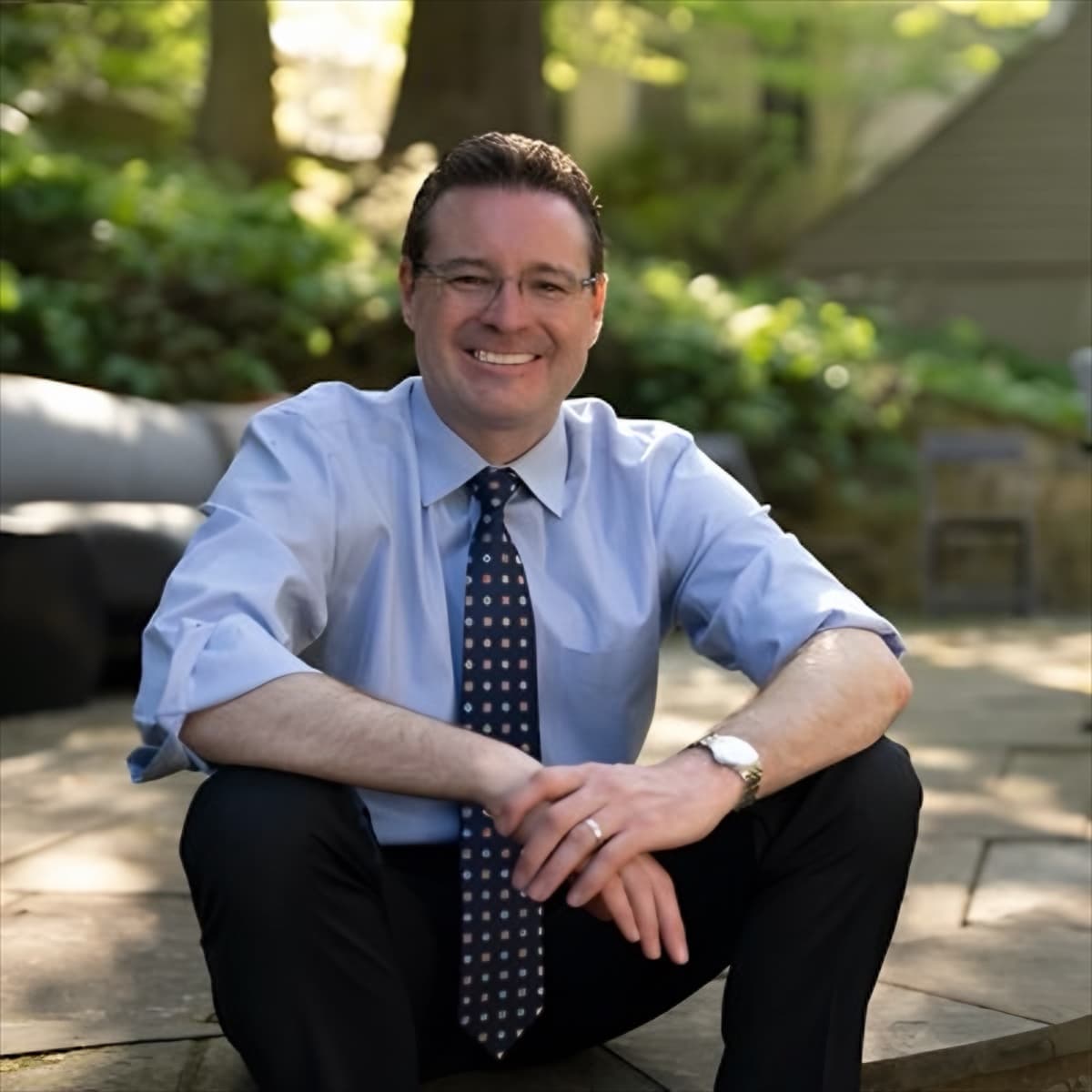 Eric Goulet sitting outdoors on a stone patio